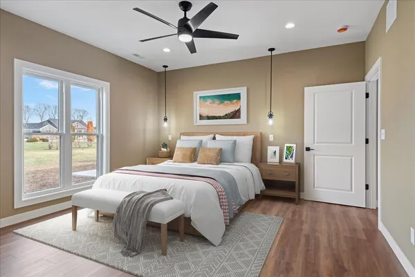 a bedroom with a large bed and a window