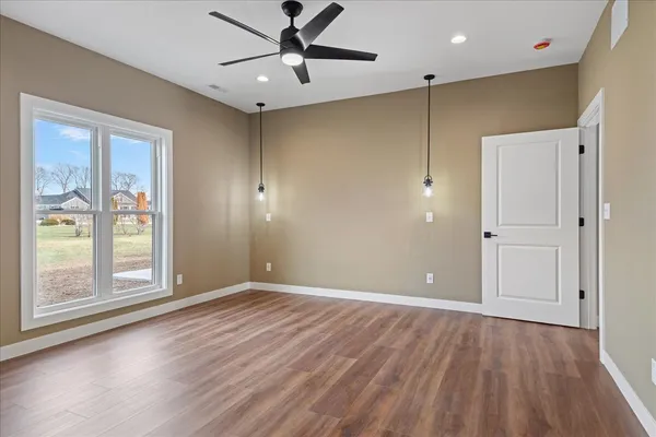 wooden floor in an empty room with a window