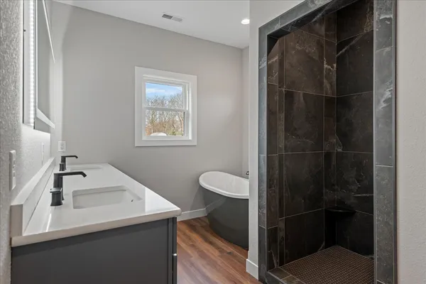 a bathroom with a shower sink and toilet