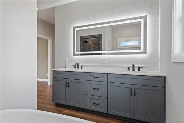 a bathroom with a toilet sink and mirror