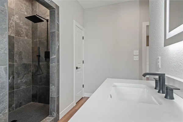 a bathroom with a bathtub and a shower