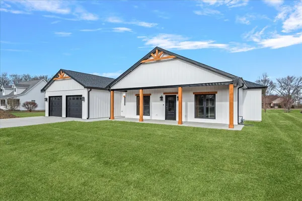 a front view of a house with a yard and garage