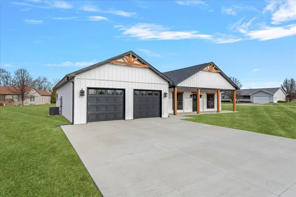 a front view of a house with a yard and garage
