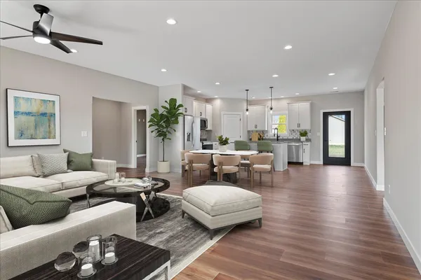 a living room with furniture and a wooden floor