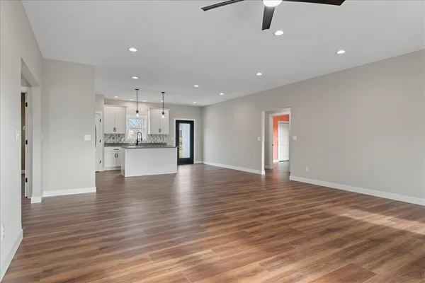a view of kitchen view wooden floor kitchen appliances and cabinets