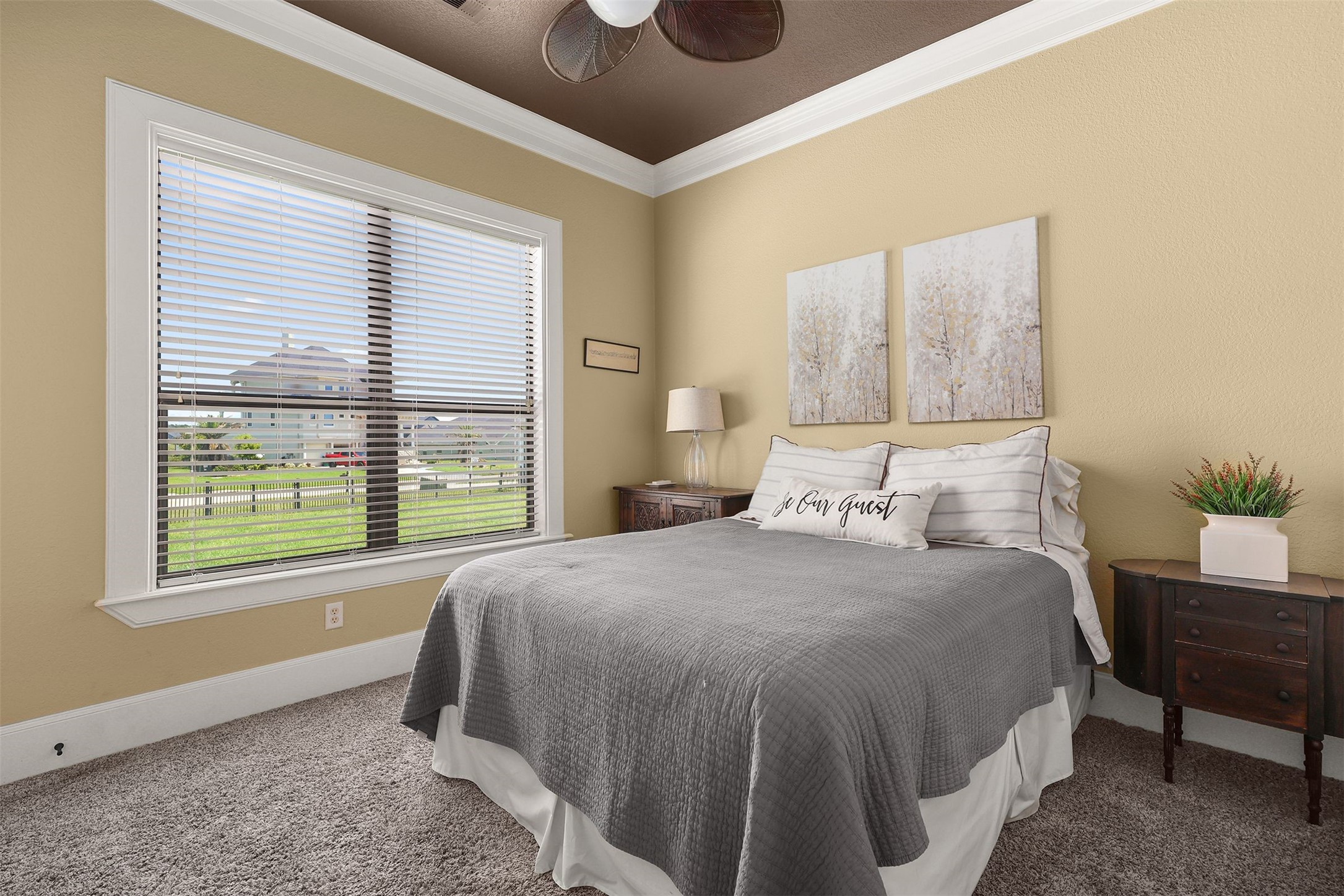 10896 Decatur Street Willis, TX 77318 - Photo 19 of 50 This cozy bedroom offers a warm, welcoming atmosphere with neutral decor, a comfortable bed, and charming wall art, enhanced by a large window that fills the space with natural light and offers a lovely neighborhood view.