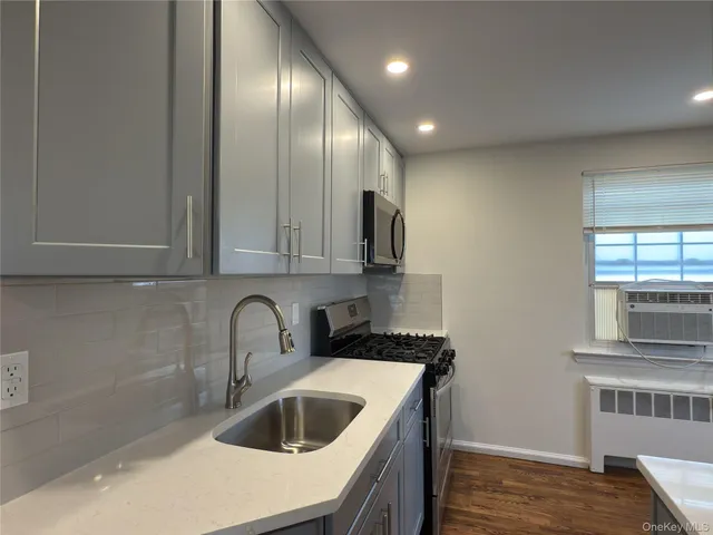 a kitchen with a sink and cabinets