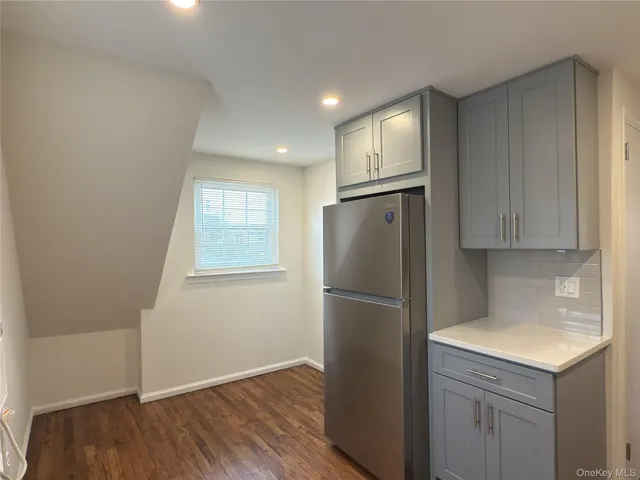 a kitchen with a refrigerator sink and cabinets