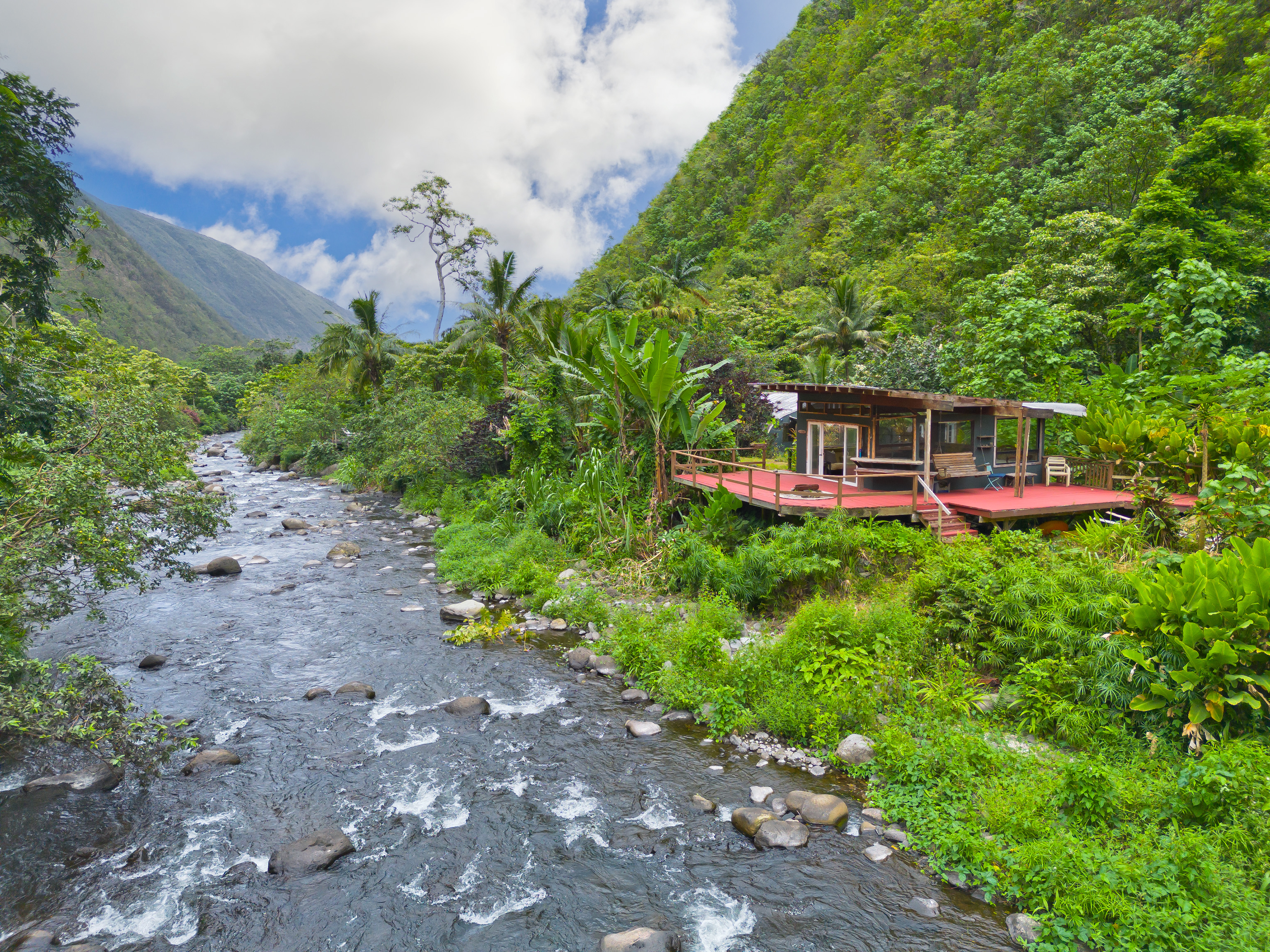 a view of a house with a yard and sitting area