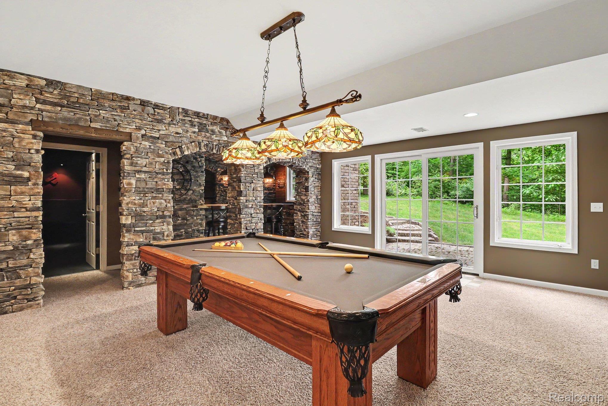 10490 Deer Ridge Trail Holly, MI 48442 - Photo 38 of 56 Recreation room featuring a pool table, stone accent walls, and recessed lighting
