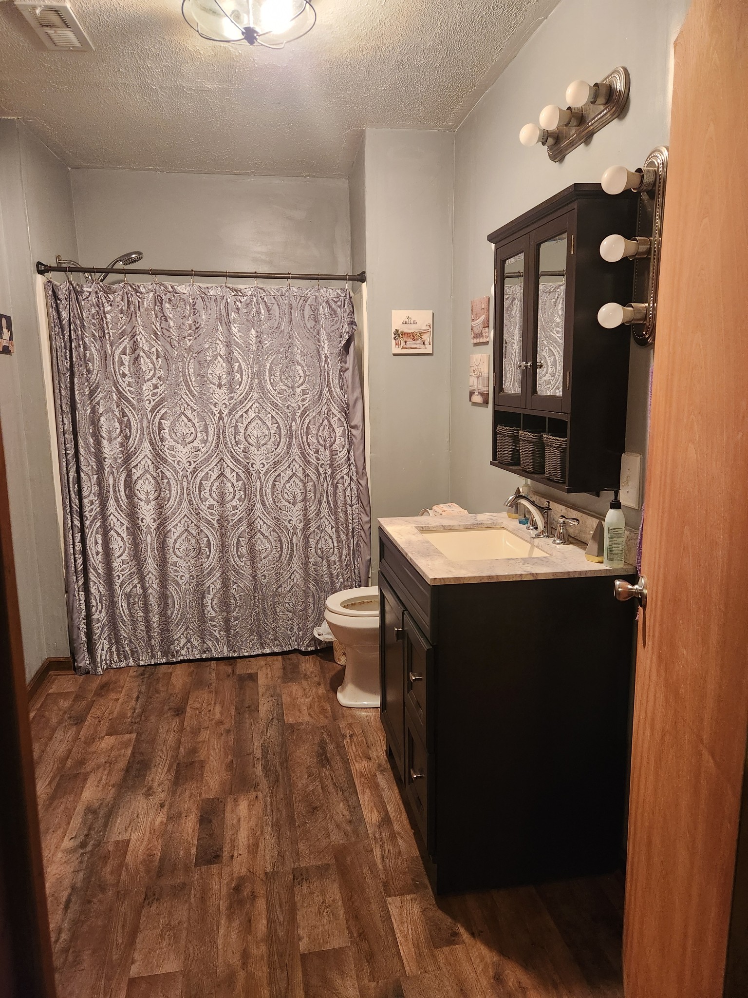 300 South Russell Street Portland, TN 37148 - Photo 13 of 14 a bathroom with a sink and a mirror