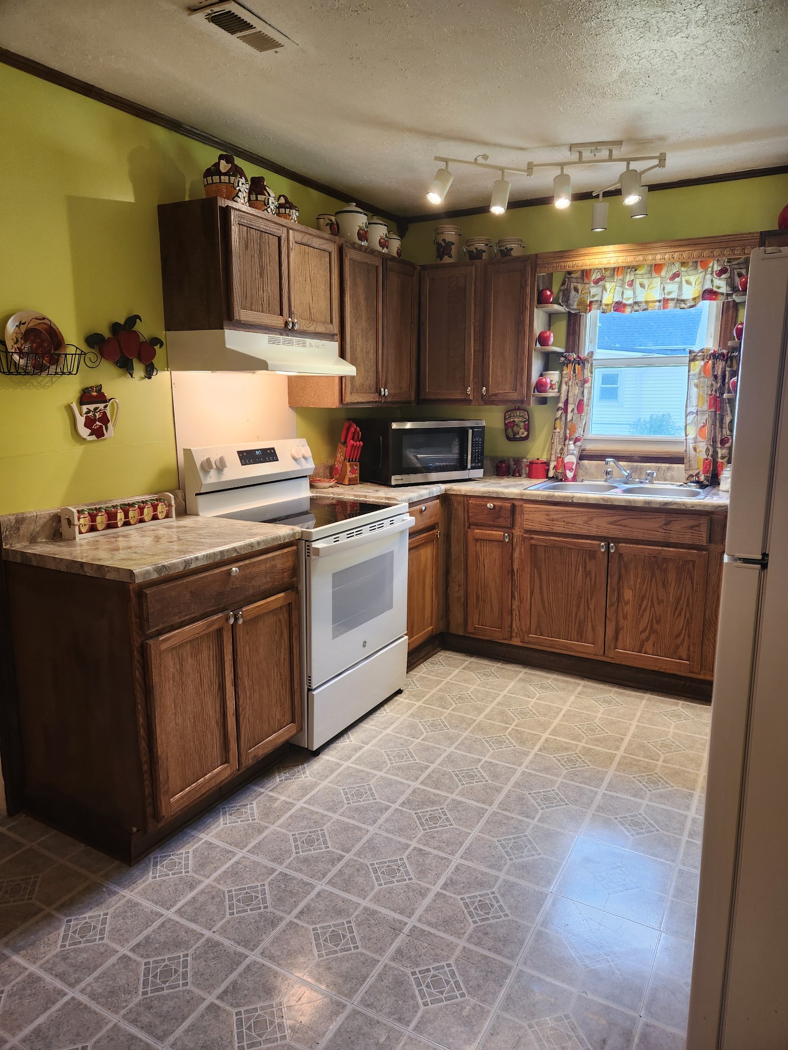 300 South Russell Street Portland, TN 37148 - Photo 6 of 14 a kitchen with stainless steel appliances granite countertop a stove sink and cabinets