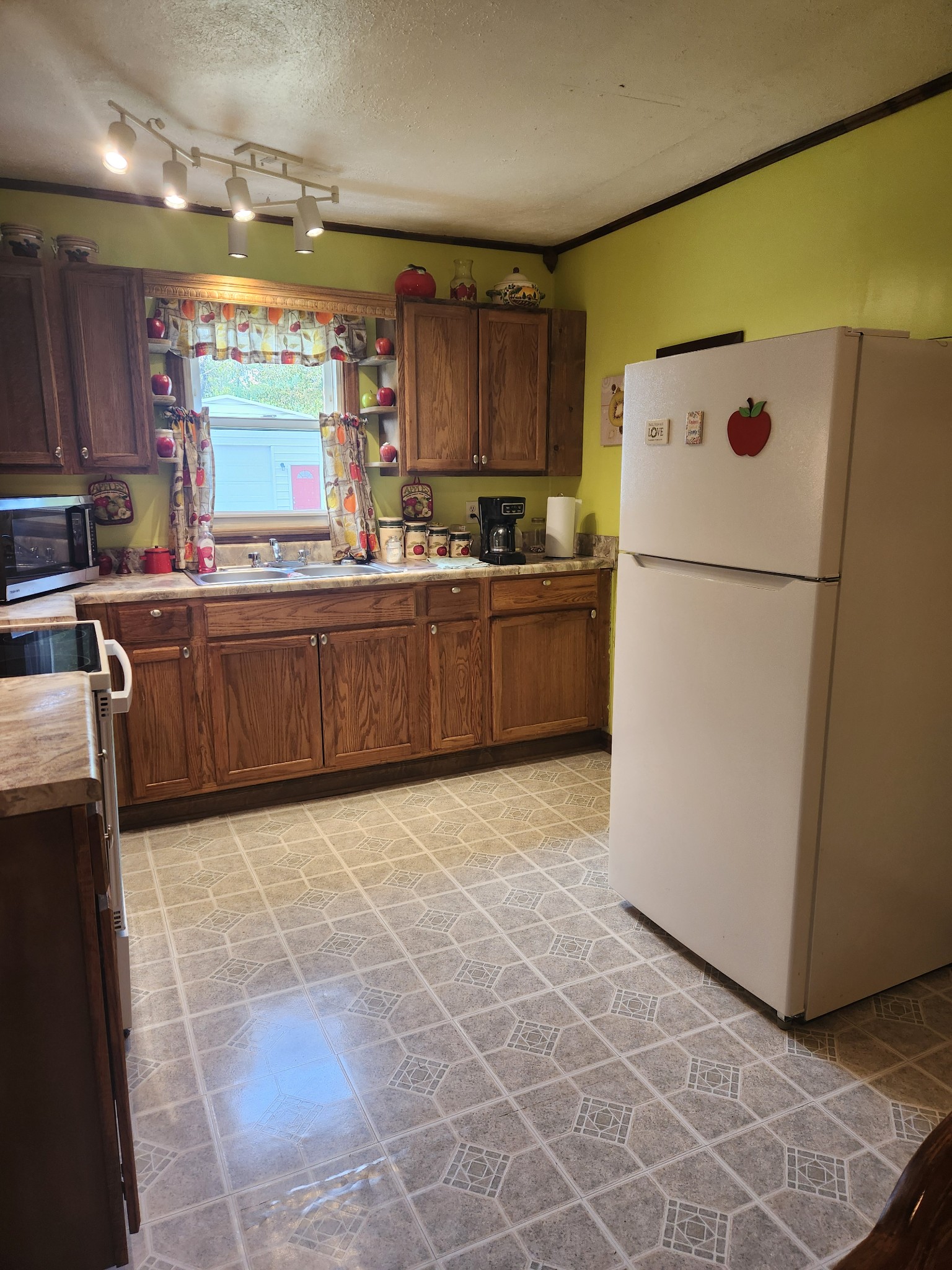 300 South Russell Street Portland, TN 37148 - Photo 7 of 14 a kitchen with granite countertop a refrigerator a sink and dishwasher
