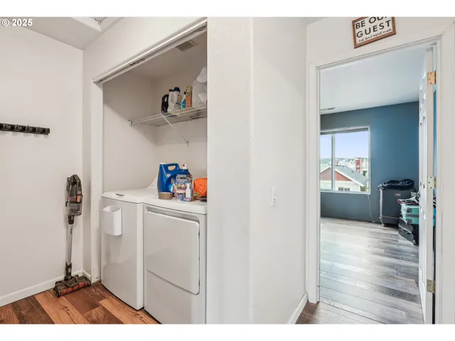 a hallway with cabinets and wooden floor