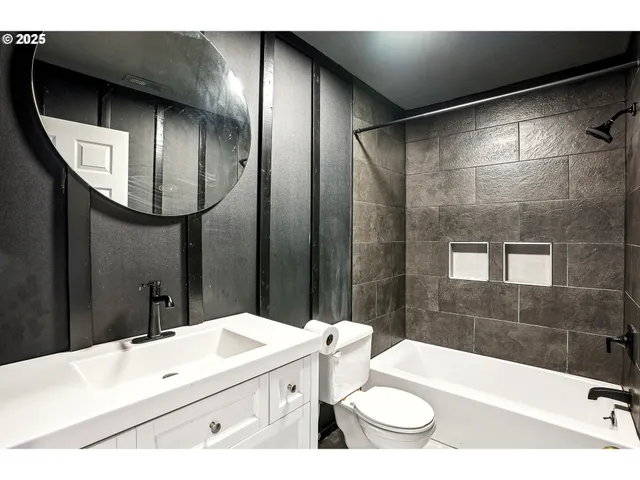 a bathroom with a sink a toilet and a mirror