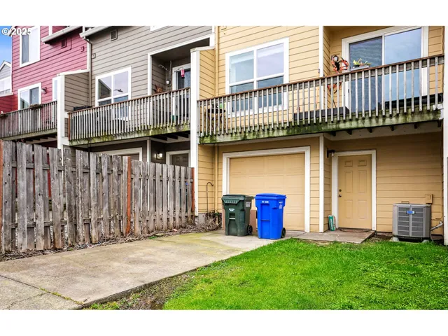 a view of a house with wooden fence