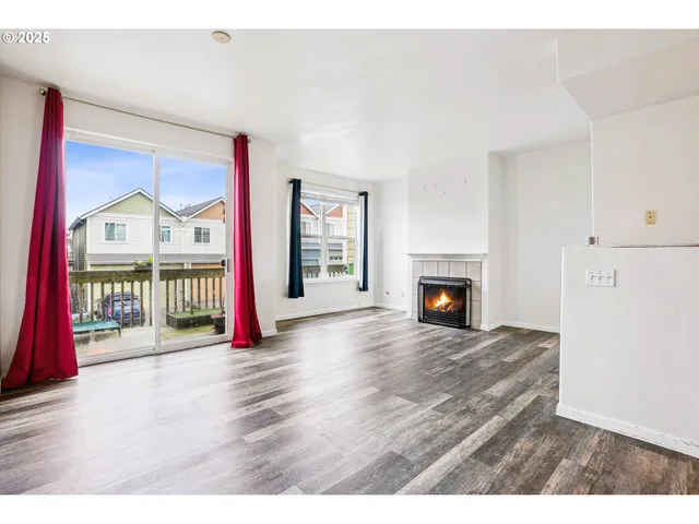 a view interior of a house with wooden floor fireplace and windows
