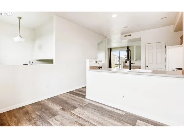 a kitchen with kitchen island sink and refrigerator