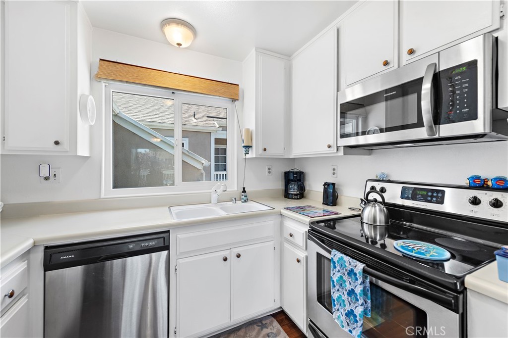 34110 Selva Road, Unit 321 Dana Point, CA 92629 - Photo 17 of 29 a kitchen with stainless steel appliances a stove a sink and cabinets
