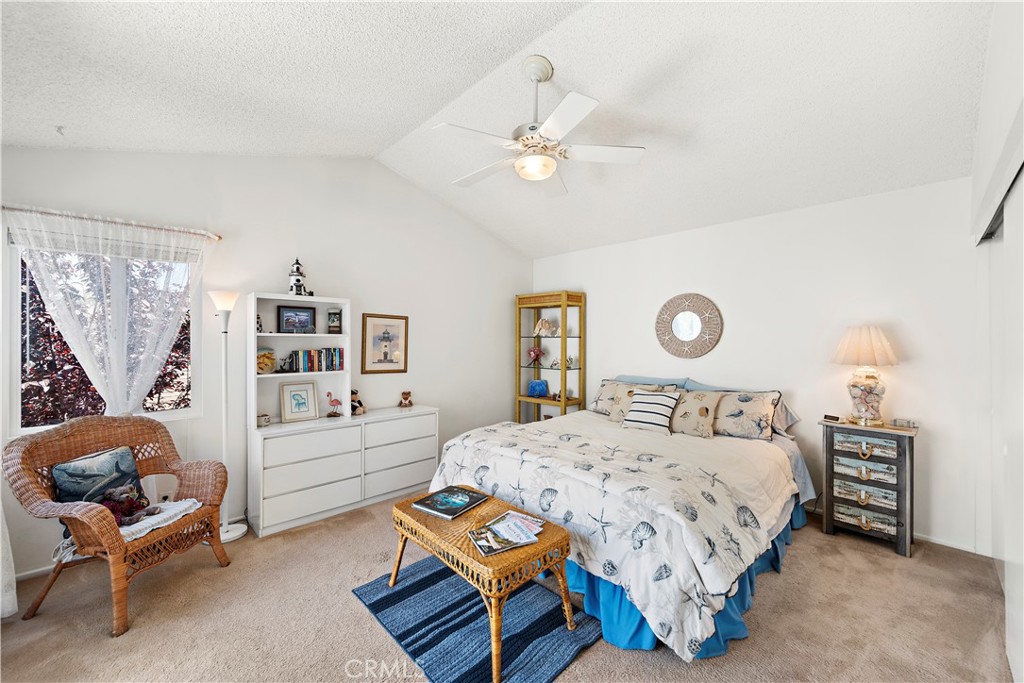 34110 Selva Road, Unit 321 Dana Point, CA 92629 - Photo 21 of 29 a bedroom with a bed and a chandelier