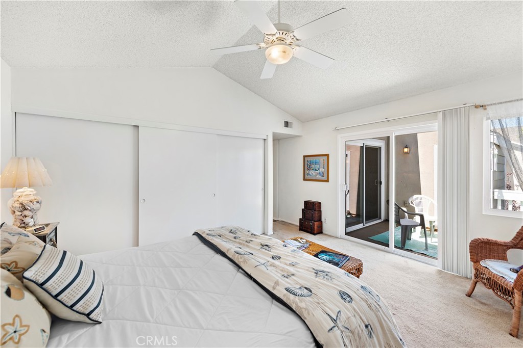34110 Selva Road, Unit 321 Dana Point, CA 92629 - Photo 22 of 29 a bedroom with a large bed and a chandelier
