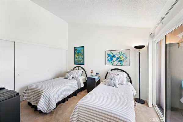 a bedroom with two beds and a window