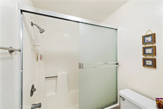a bathroom with a shower and a toilet