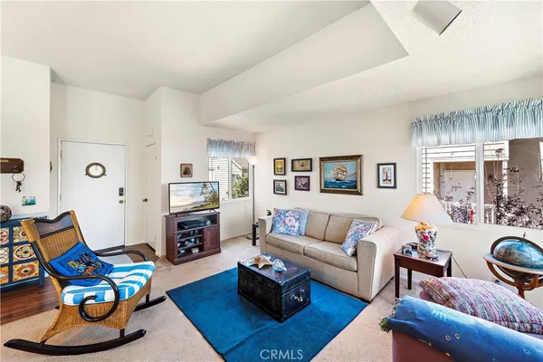 a living room with furniture fireplace and a table
