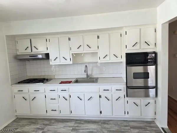 a kitchen with stainless steel appliances granite countertop a sink and a stove