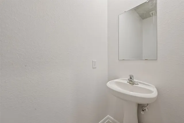a view of a room with a ceiling fan and window