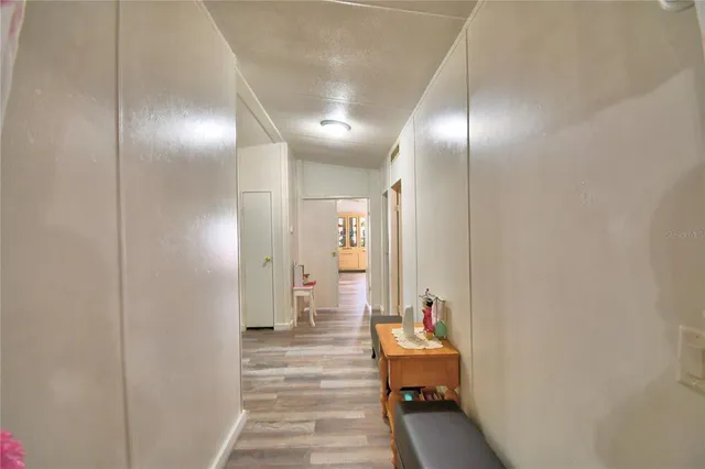 a view of a livingroom with dining room and wooden floor