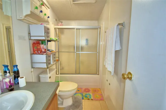 a kitchen with stainless steel appliances granite countertop a refrigerator a stove and a sink