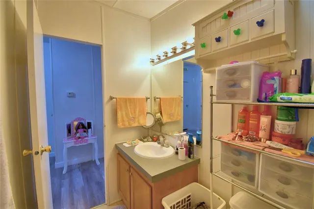 a kitchen with stainless steel appliances granite countertop a refrigerator a sink dishwasher a stove and white countertops with wooden floor