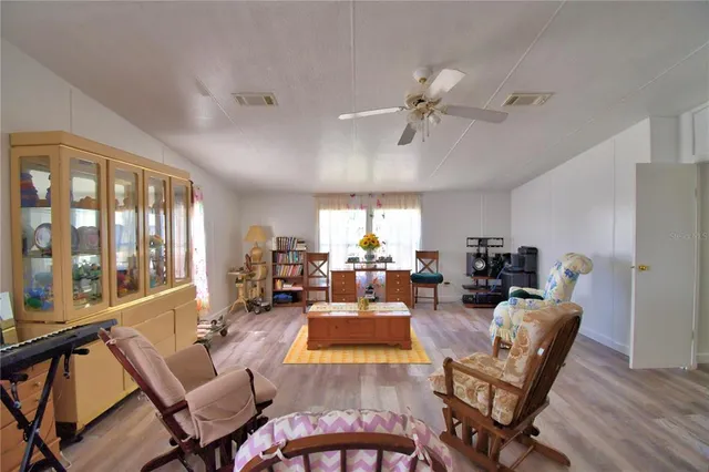 a living room with a couch swing table and chairs