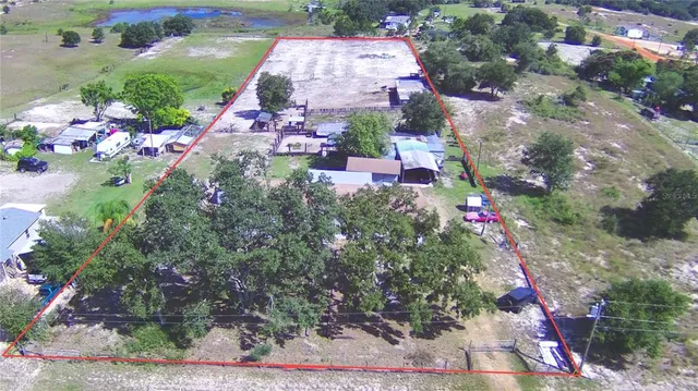 a view of a chair and tables in the back yard of the house
