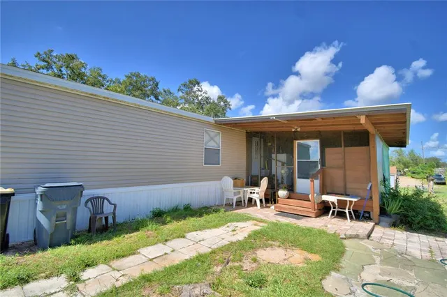 a living room with furniture a desk and chair with wooden floor