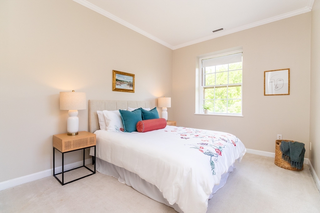 60e Glen Road, Unit 306 Brookline, MA 02445 - Photo 17 of 27 a bedroom with a bed and a window