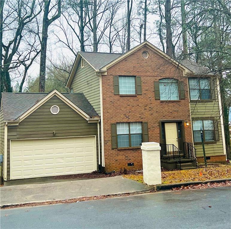 3855 Rainover Drive Decatur, GA 30034 - Photo 1 of 1 a front view of a house with a yard and garage