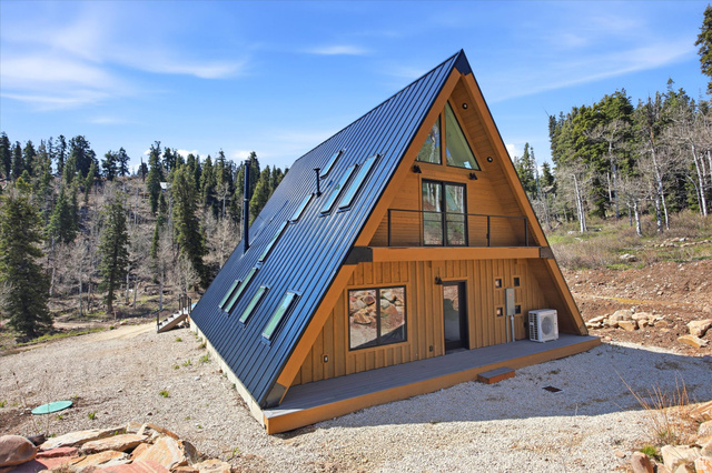 1833 Pine Loop Road Coalville, UT 84017 - Photo 22 of 26 A-frame architectural design featuring natural wood siding and a dark metal roof