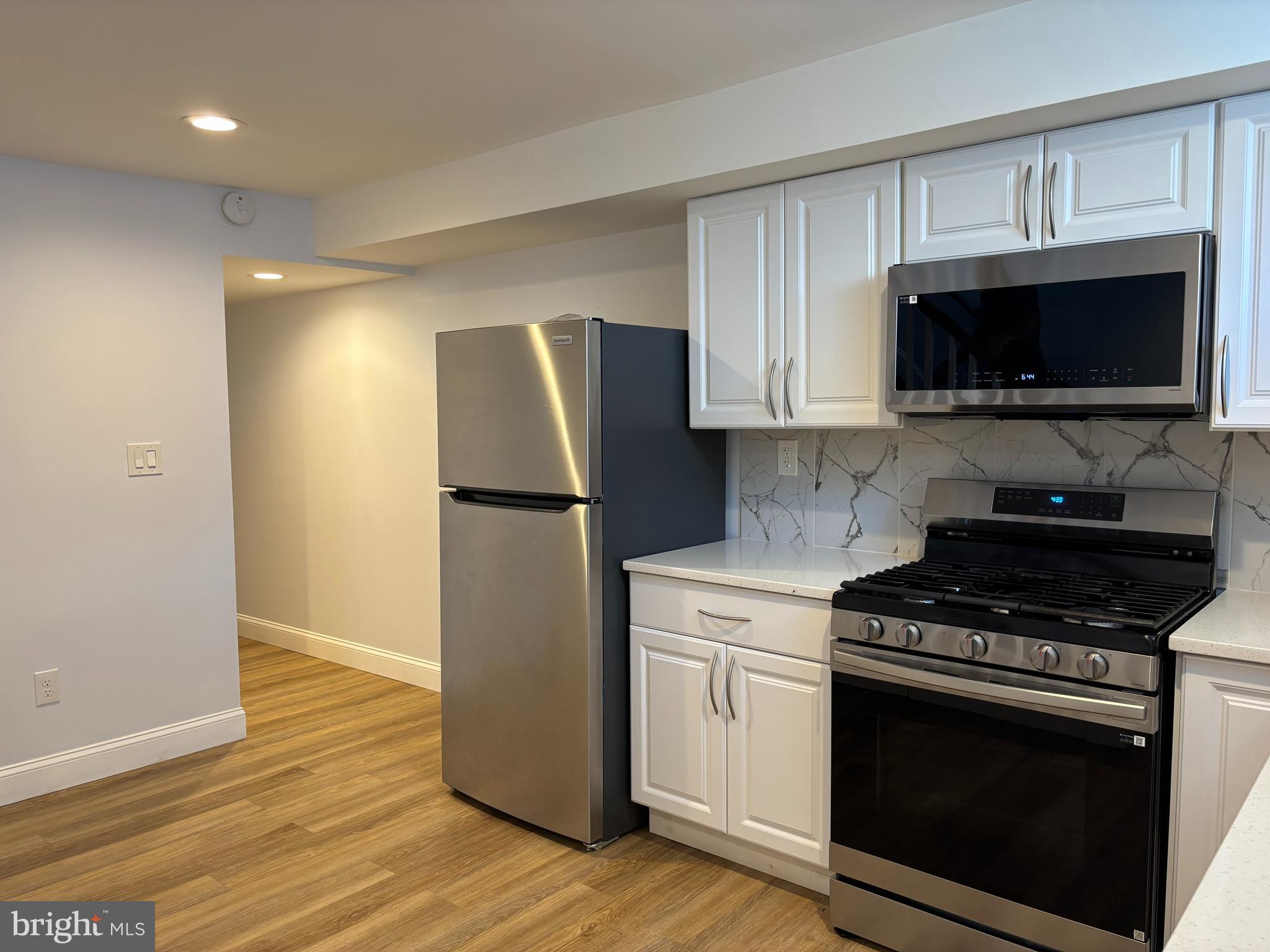 2505 Federal Street Baltimore, MD 21213 - Photo 18 of 26 a kitchen with cabinets and steel stainless steel appliances