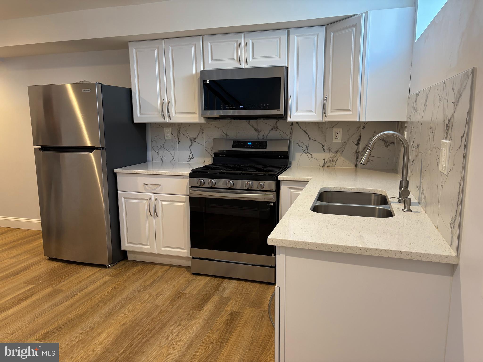 2505 Federal Street Baltimore, MD 21213 - Photo 20 of 26 a kitchen with a refrigerator stove and microwave
