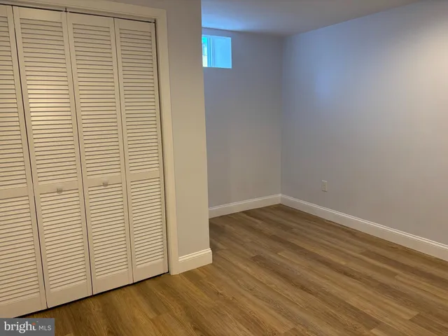 an empty room with wooden floor