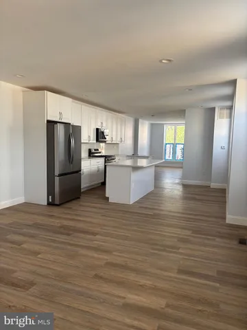 a view of a kitchen with a refrigerator a sink and dishwasher