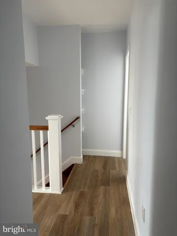 a view of a hallway to rooms