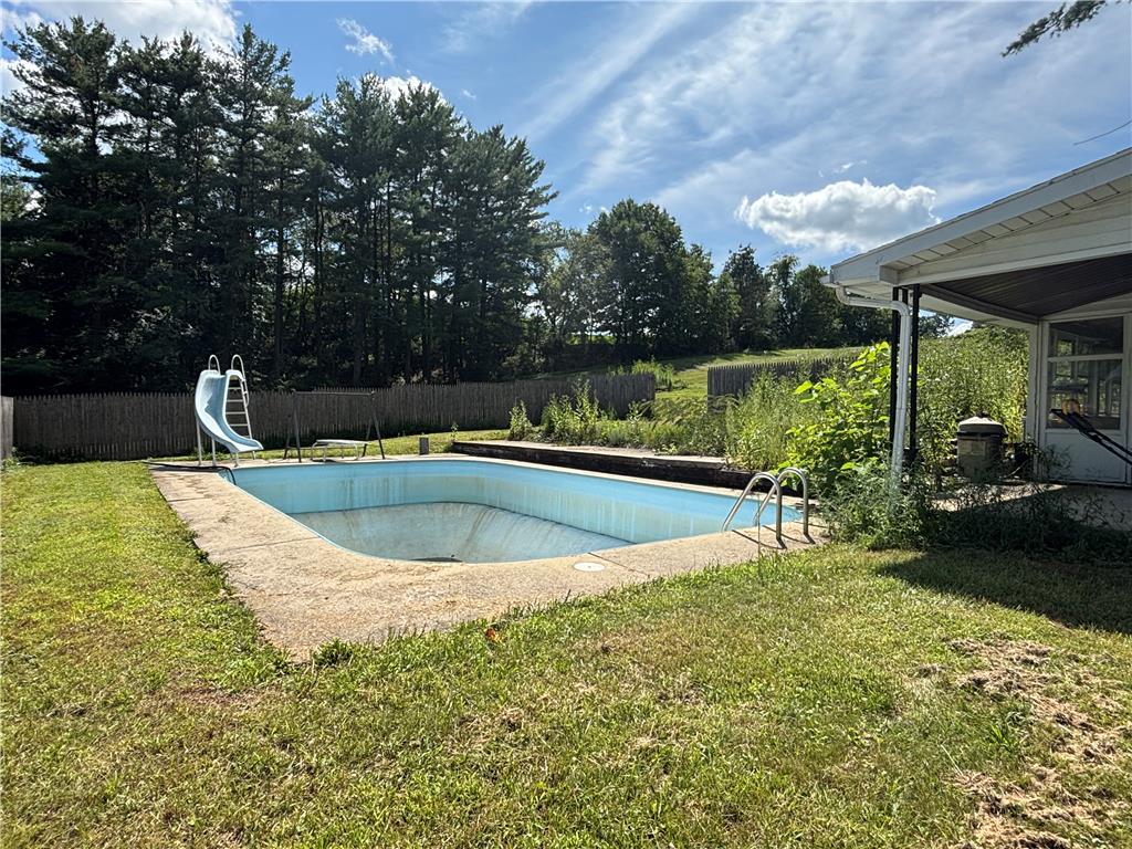 231 Laurel Road Lehighton, PA 18235 - Photo 29 of 36 An in-ground swimming pool sits framed by green lawns and mature boundary trees.
