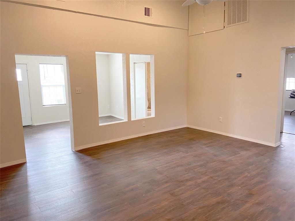 a view of a room with wooden floor and white walls