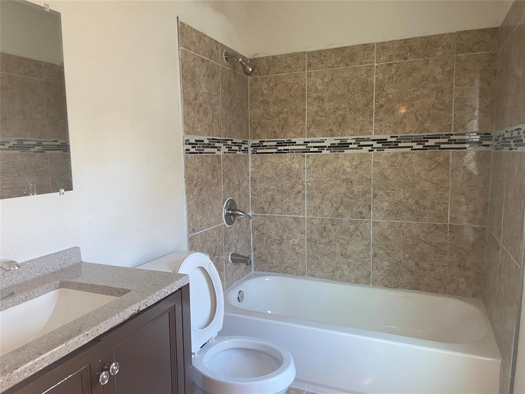 12115 Segrest Drive Houston, TX 77047 - Photo 12 of 13 a bathroom with a granite countertop sink toilet and bathtub