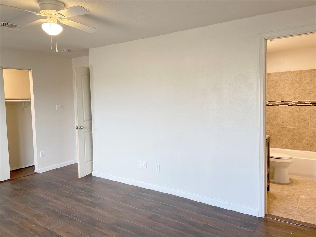 12115 Segrest Drive Houston, TX 77047 - Photo 4 of 13 an empty room with wooden floor and windows