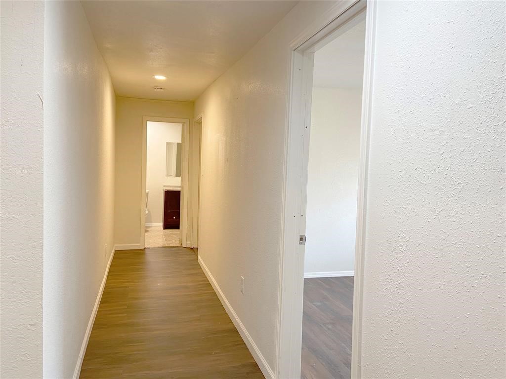 12115 Segrest Drive Houston, TX 77047 - Photo 7 of 13 a view of a hallway with wooden floor