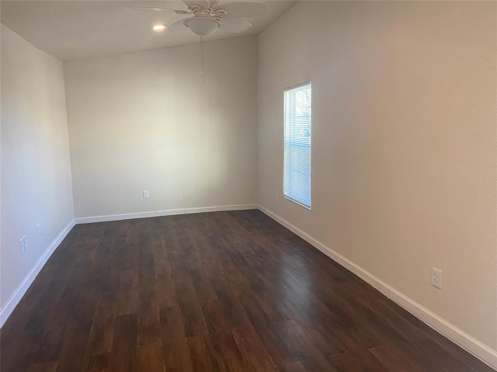 12115 Segrest Drive Houston, TX 77047 - Photo 10 of 13 an empty room with wooden floor and windows
